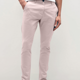 Mens pale pink chinos with front slanted pockets, jetted back pockets. zip fly fastening and brown horne buttons on the waistband and back pockets, the fit is a slim fit, this is worn with a white tee and white unbranded trainers