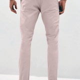 Mens pale pink chinos with front slanted pockets, jetted back pockets. zip fly fastening and brown horne buttons on the waistband and back pockets, the fit is a slim fit, this is worn with a white tee and white unbranded trainers