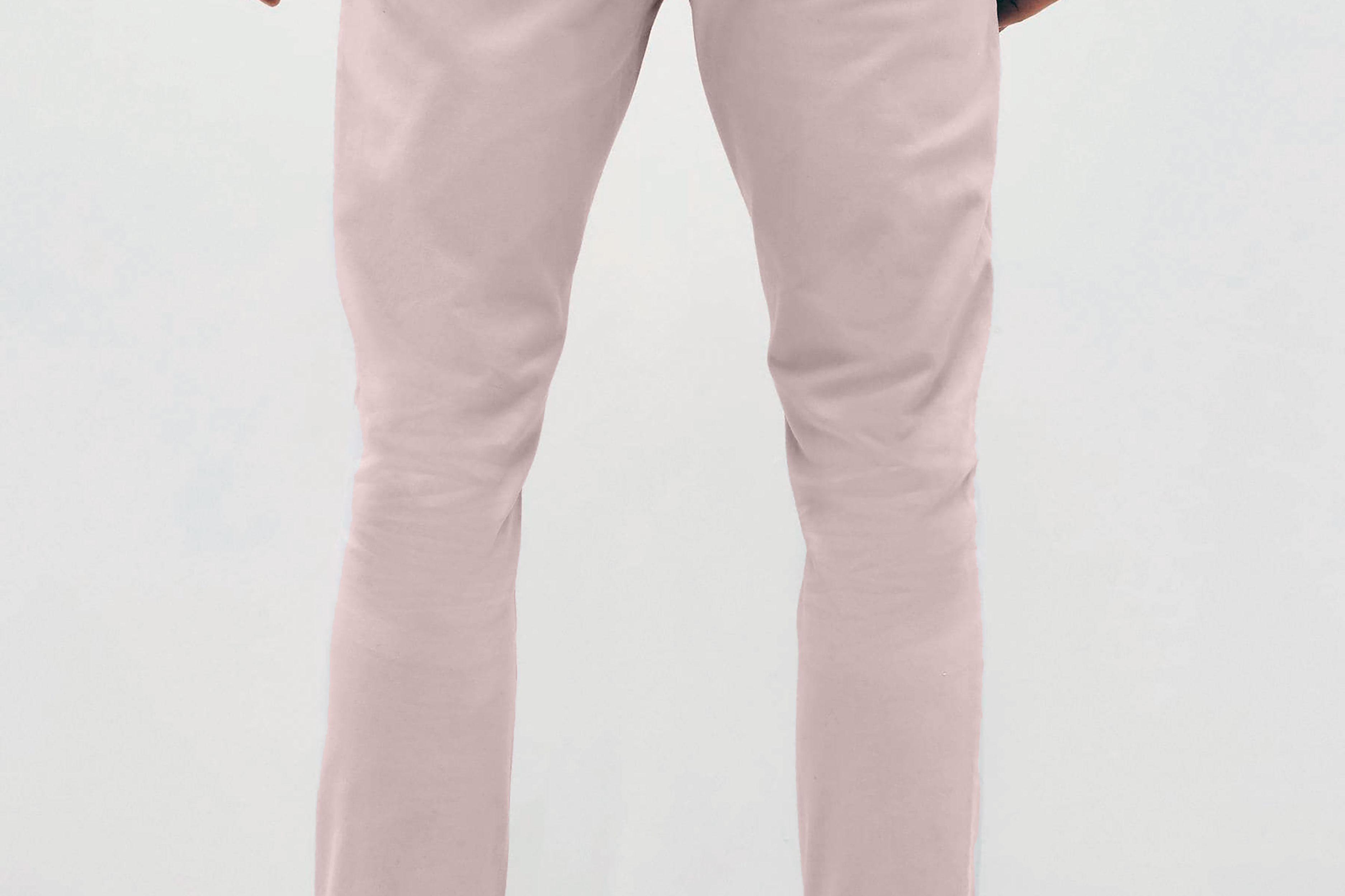 Mens pale pink chinos with front slanted pockets, jetted back pockets. zip fly fastening and brown horne buttons on the waistband and back pockets, the fit is a slim fit, this is worn with a white tee and white unbranded trainers