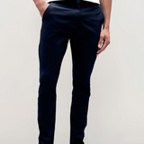 Mens Navy chinos with front slanted pockets, jetted back pockets. zip fly fastening and brown horne buttons on the waistband and back pockets, the fit is a slim fit, this is worn with a white tee and white unbranded trainers