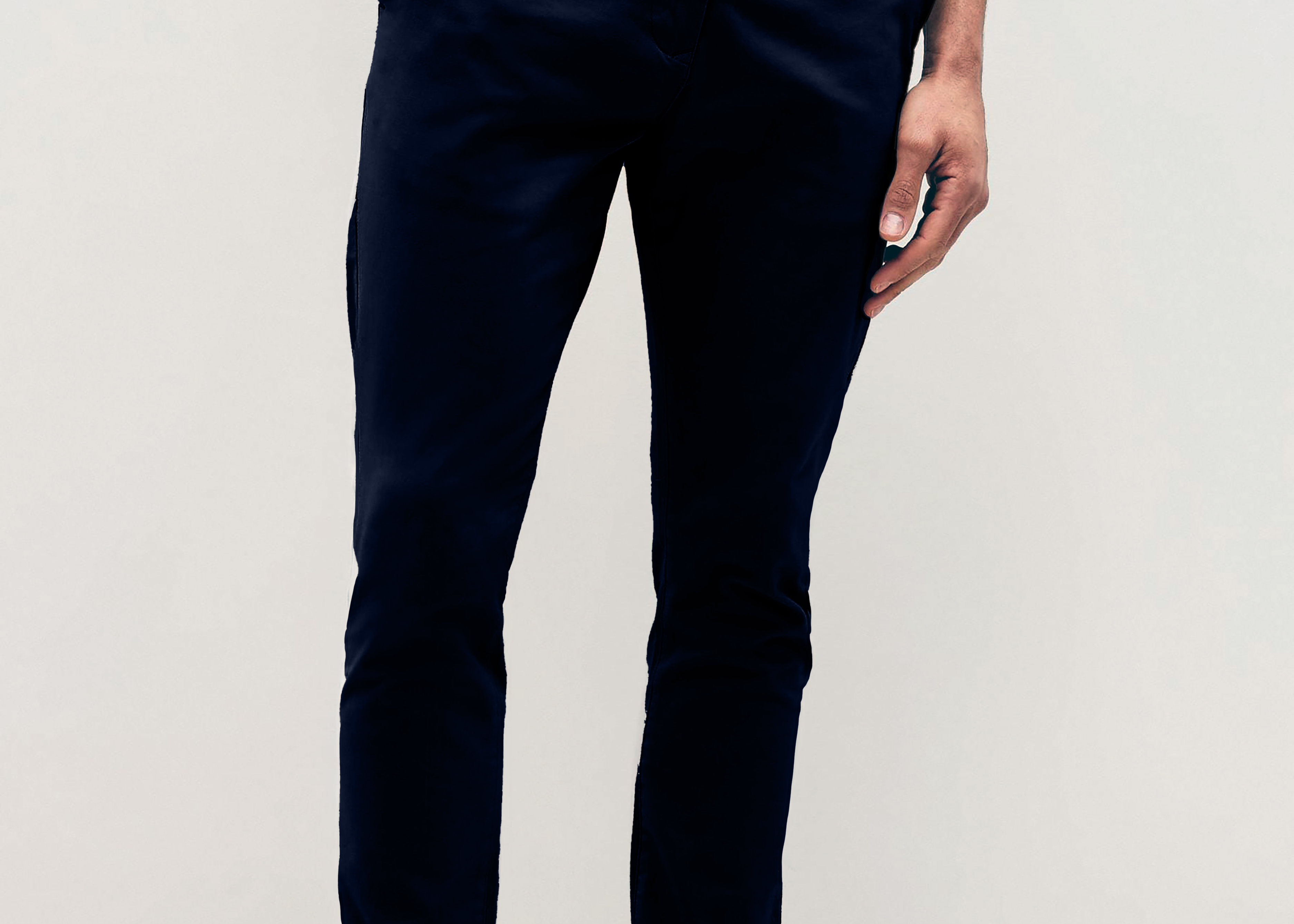 Mens Navy chinos with front slanted pockets, jetted back pockets. zip fly fastening and brown horne buttons on the waistband and back pockets, the fit is a slim fit, this is worn with a white tee and white unbranded trainers