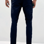 Mens Navy chinos with front slanted pockets, jetted back pockets. zip fly fastening and brown horne buttons on the waistband and back pockets, the fit is a slim fit, this is worn with a white tee and white unbranded trainers