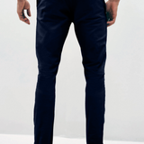 Mens Navy chinos with front slanted pockets, jetted back pockets. zip fly fastening and brown horne buttons on the waistband and back pockets, the fit is a slim fit, this is worn with a white tee and white unbranded trainers