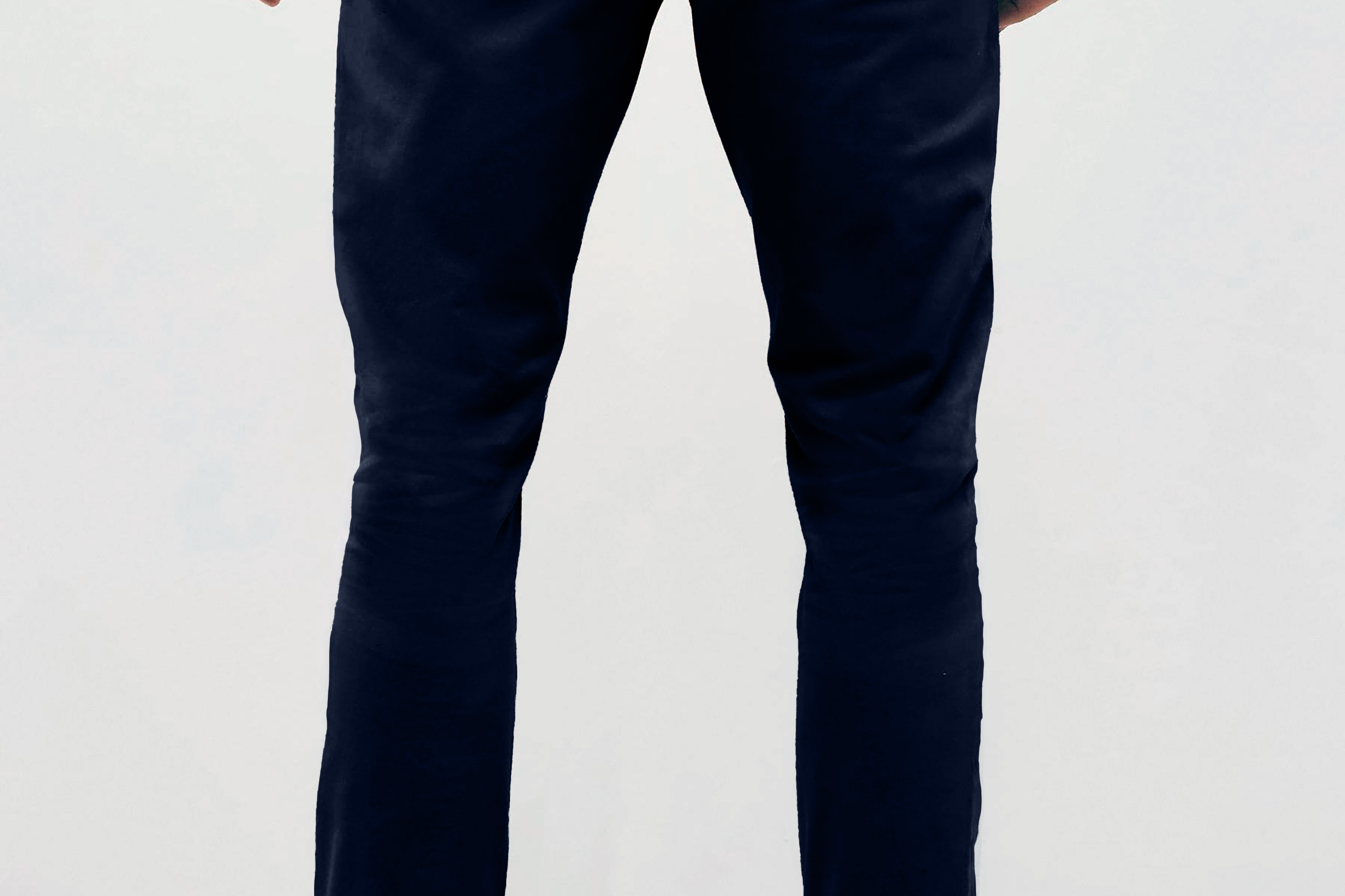 Mens Navy chinos with front slanted pockets, jetted back pockets. zip fly fastening and brown horne buttons on the waistband and back pockets, the fit is a slim fit, this is worn with a white tee and white unbranded trainers