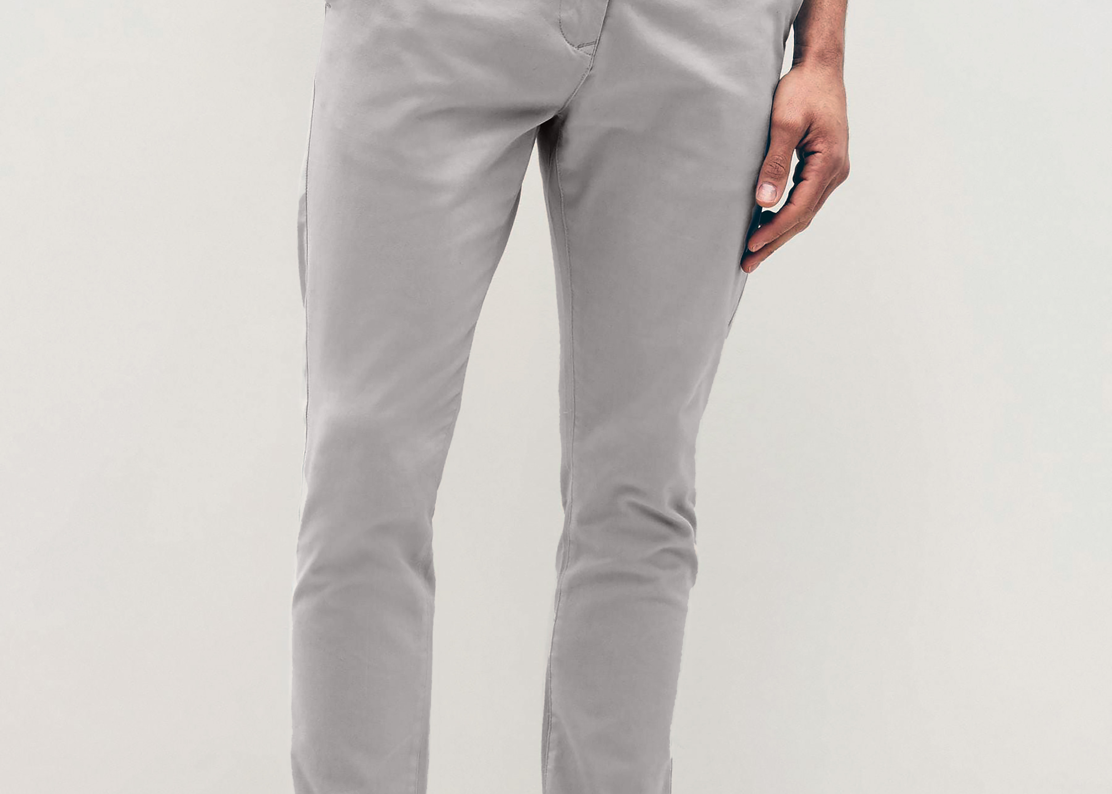 Mens Silver Grey chinos with front slanted pockets, jetted back pockets. zip fly fastening and brown horne buttons on the waistband and back pockets, the fit is a slim fit, this is worn with a white tee and white unbranded trainers