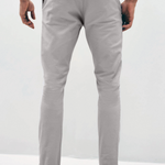 Mens Silver Grey chinos with front slanted pockets, jetted back pockets. zip fly fastening and brown horne buttons on the waistband and back pockets, the fit is a slim fit, this is worn with a white tee and white unbranded trainers