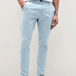 Mens sky Blue chinos with front slanted pockets, jetted back pockets. zip fly fastening and brown horne buttons on the waistband and back pockets, the fit is a slim fit, this is worn with a white tee and white unbranded trainers