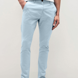 Mens sky Blue chinos with front slanted pockets, jetted back pockets. zip fly fastening and brown horne buttons on the waistband and back pockets, the fit is a slim fit, this is worn with a white tee and white unbranded trainers