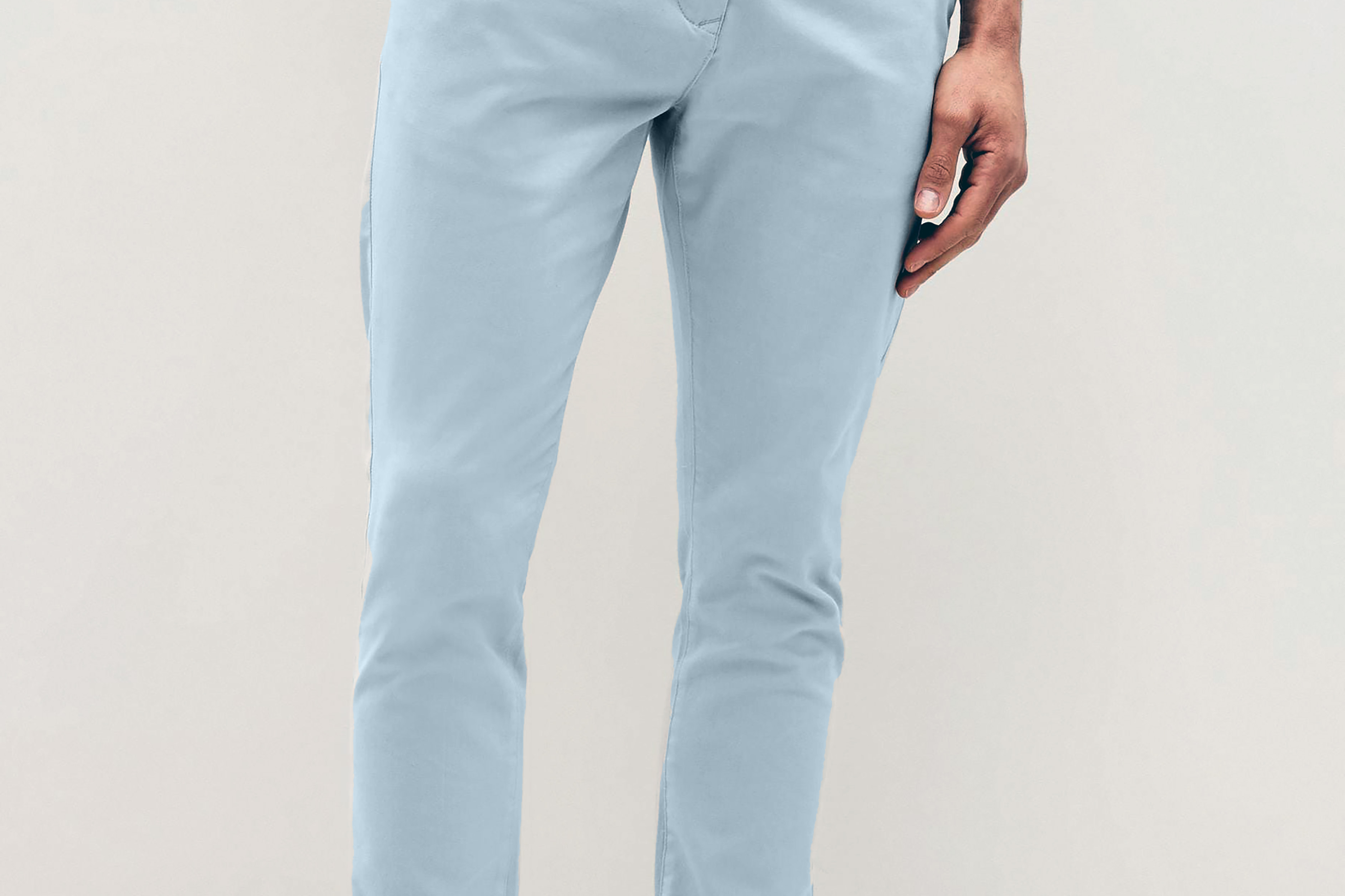 Mens sky Blue chinos with front slanted pockets, jetted back pockets. zip fly fastening and brown horne buttons on the waistband and back pockets, the fit is a slim fit, this is worn with a white tee and white unbranded trainers