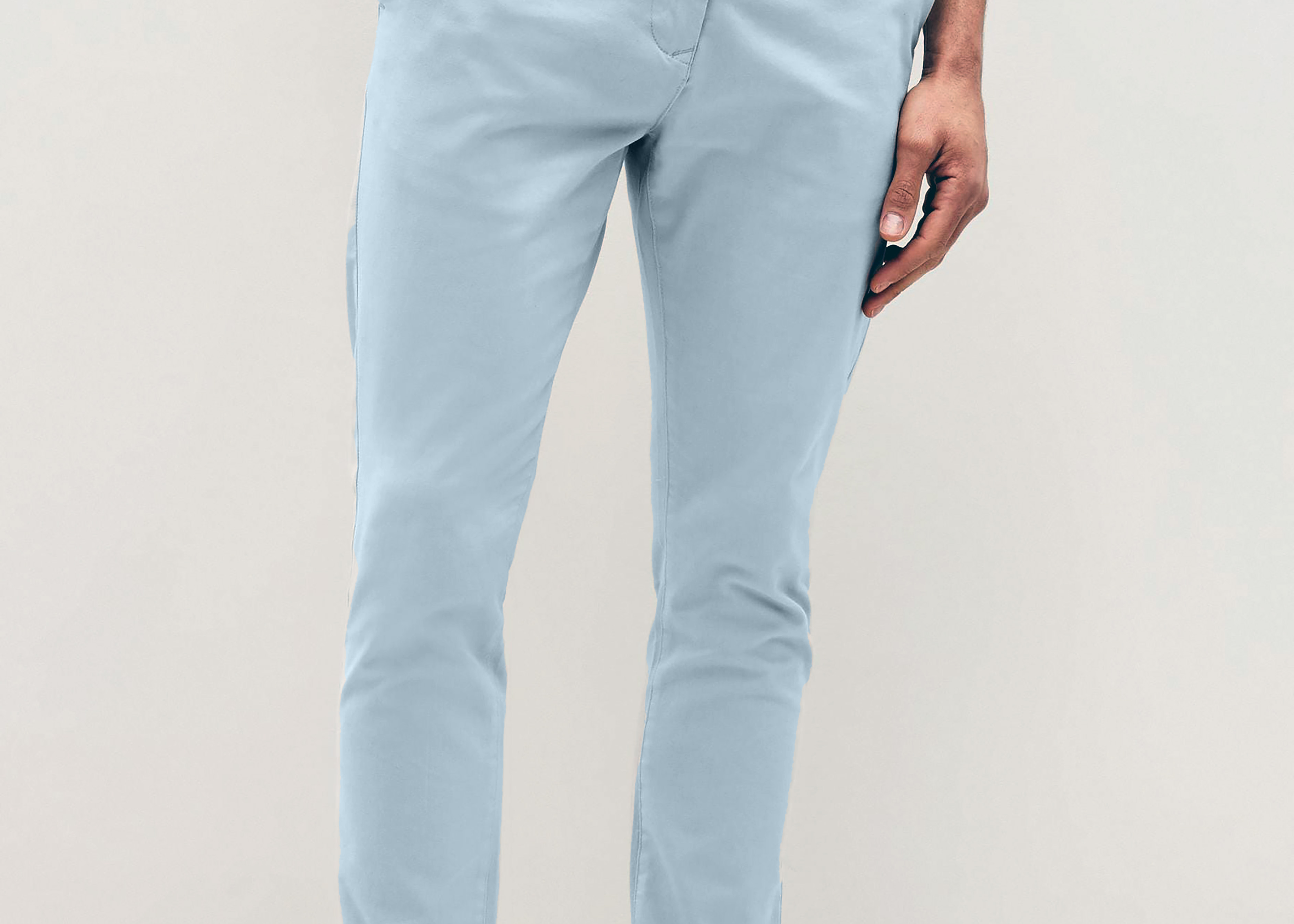 Mens sky Blue chinos with front slanted pockets, jetted back pockets. zip fly fastening and brown horne buttons on the waistband and back pockets, the fit is a slim fit, this is worn with a white tee and white unbranded trainers