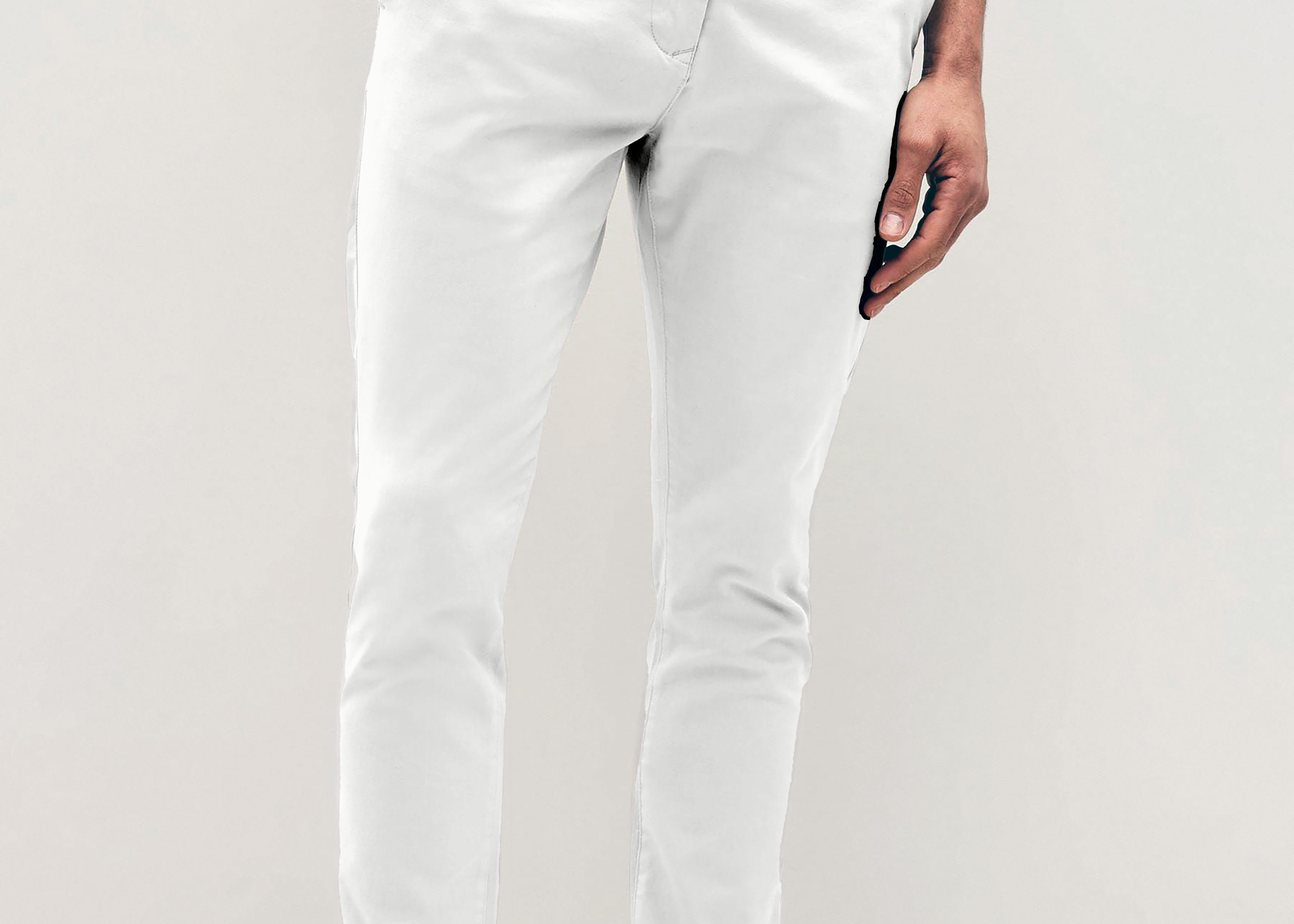 Mens white chinos with front slanted pockets, jetted back pockets. zip fly fastening and brown horne buttons on the waistband and back pockets, the fit is a slim fit, this is worn with a white tee and white unbranded trainers