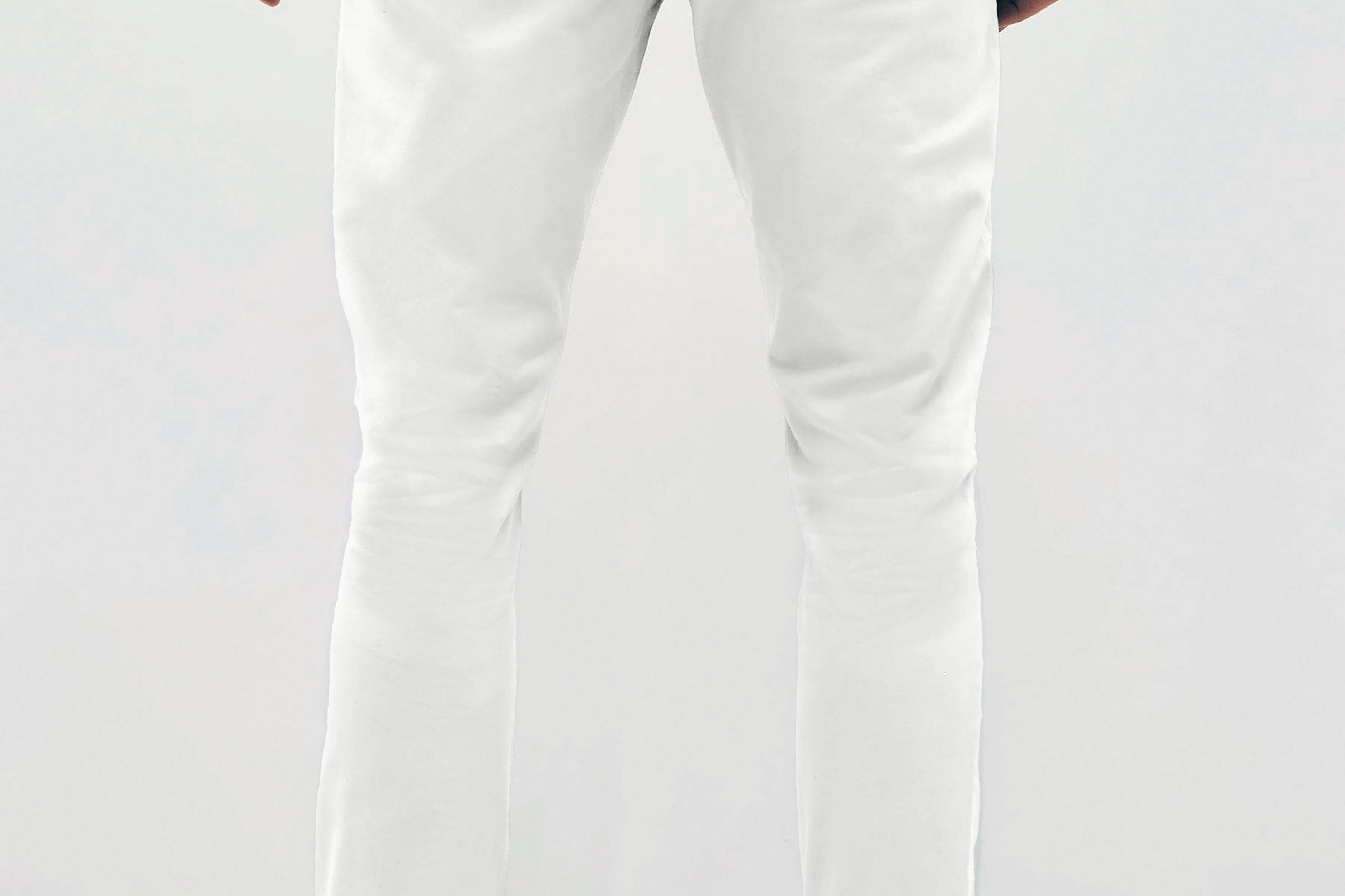 Mens white chinos with front slanted pockets, jetted back pockets. zip fly fastening and brown horne buttons on the waistband and back pockets, the fit is a slim fit, this is worn with a white tee and white unbranded trainers