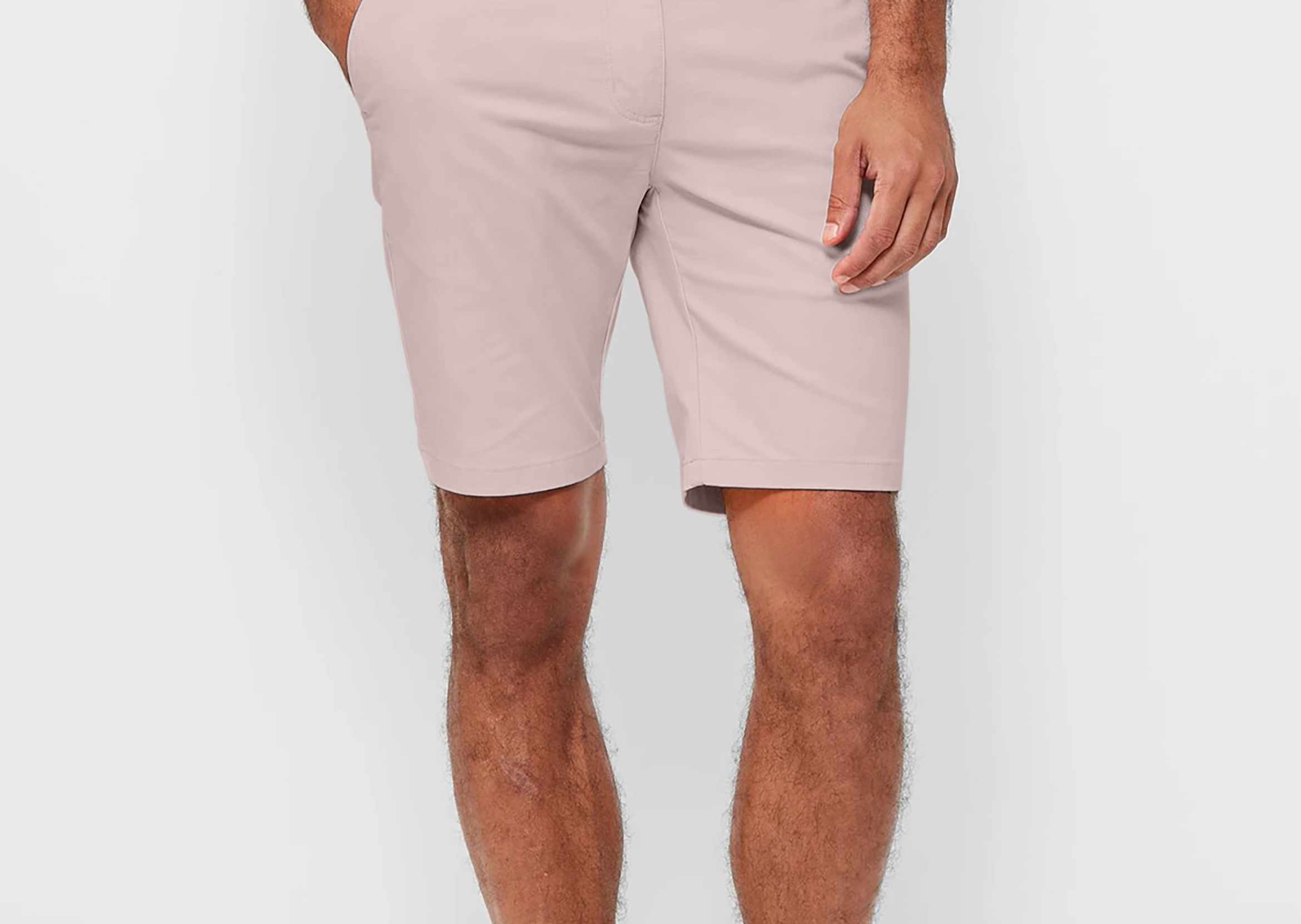 Mens pale pink chinos shorts with front slanted pockets, jetted back pockets. zip fly fastening and brown horne buttons on the waistband and back pockets, the fit is a slim fit, this is worn with a white tee and white t-shirt