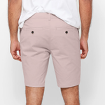 Mens pale pink chinos shorts with front slanted pockets, jetted back pockets. zip fly fastening and brown horne buttons on the waistband and back pockets, the fit is a slim fit, this is worn with a white tee and white t-shirt