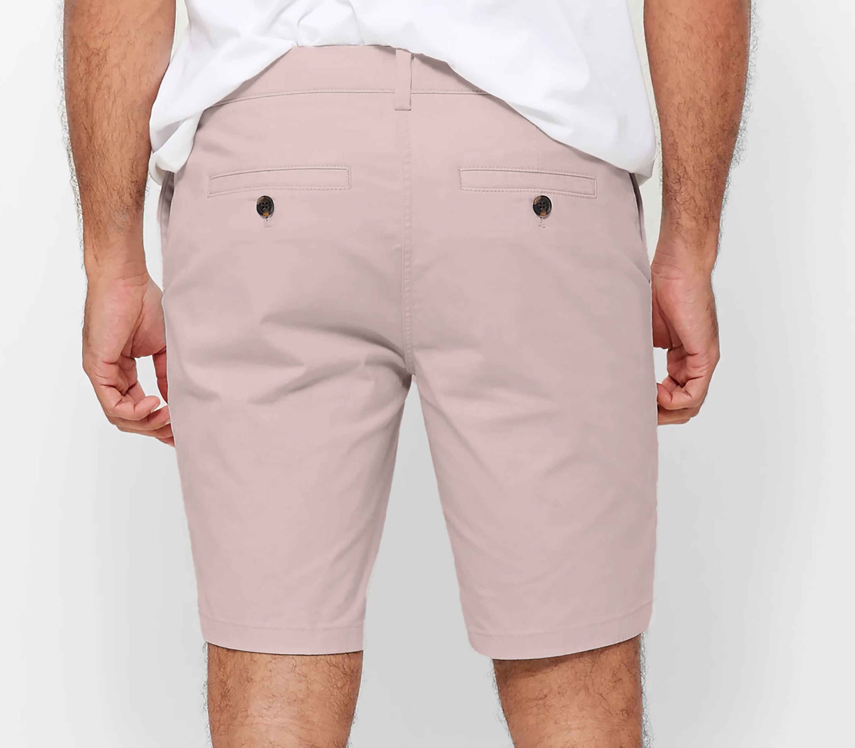 Mens pale pink chinos shorts with front slanted pockets, jetted back pockets. zip fly fastening and brown horne buttons on the waistband and back pockets, the fit is a slim fit, this is worn with a white tee and white t-shirt