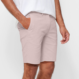 Mens pale pink chinos shorts with front slanted pockets, jetted back pockets. zip fly fastening and brown horne buttons on the waistband and back pockets, the fit is a slim fit, this is worn with a white tee and white t-shirt