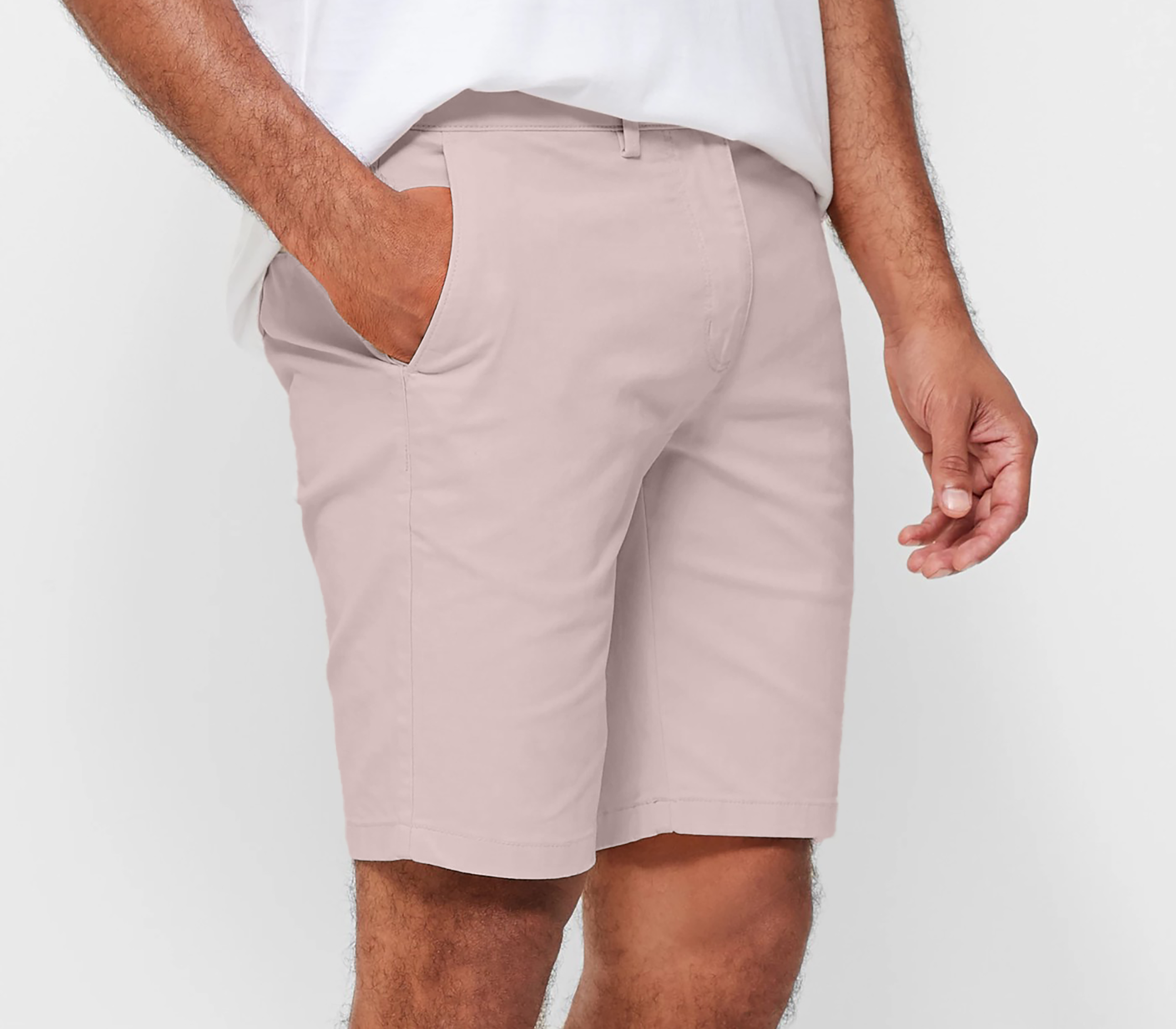 Mens pale pink chinos shorts with front slanted pockets, jetted back pockets. zip fly fastening and brown horne buttons on the waistband and back pockets, the fit is a slim fit, this is worn with a white tee and white t-shirt