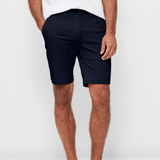 Mens Navy chinos shorts with front slanted pockets, jetted back pockets. zip fly fastening and brown horne buttons on the waistband and back pockets, the fit is a slim fit, this is worn with a white tee and white t-shirt