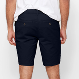 Mens Navy chinos shorts with front slanted pockets, jetted back pockets. zip fly fastening and brown horne buttons on the waistband and back pockets, the fit is a slim fit, this is worn with a white tee and white t-shirt