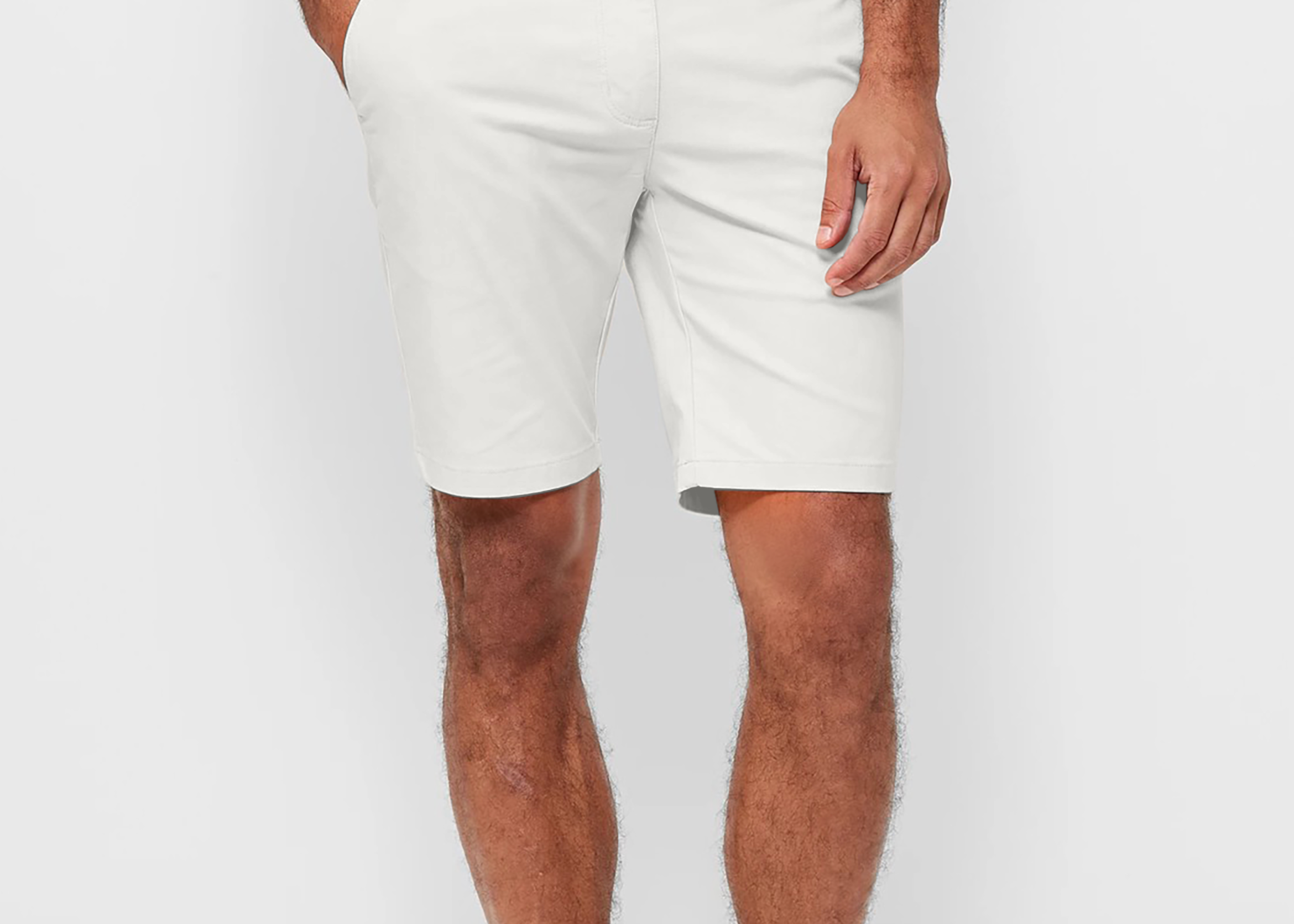 Mens White chinos shorts with front slanted pockets, jetted back pockets. zip fly fastening and brown horne buttons on the waistband and back pockets, the fit is a slim fit, this is worn with a white tee and white t-shirt