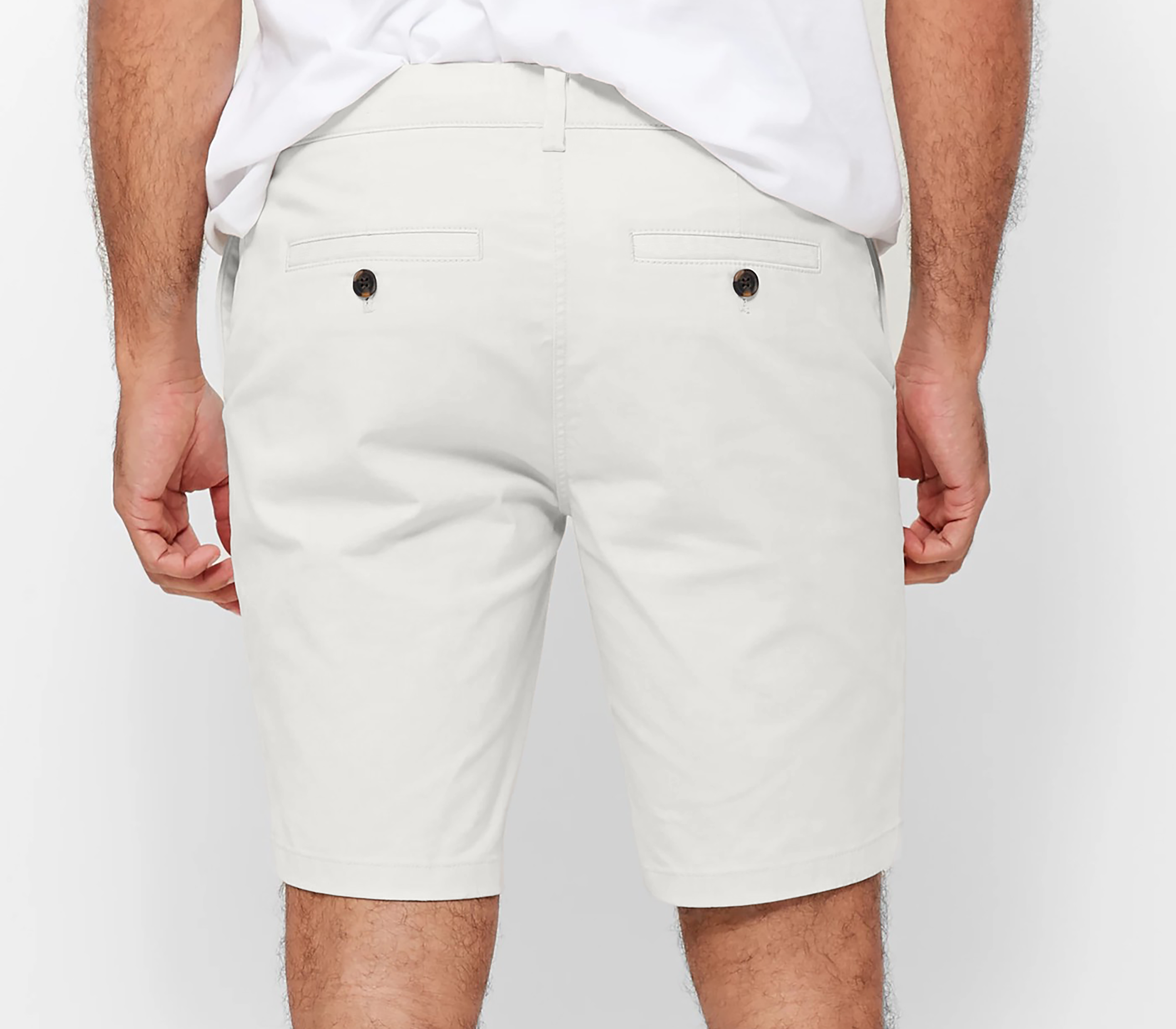 Mens White chinos shorts with front slanted pockets, jetted back pockets. zip fly fastening and brown horne buttons on the waistband and back pockets, the fit is a slim fit, this is worn with a white tee and white t-shirt