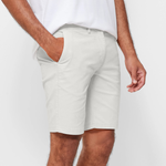 Mens White chinos shorts with front slanted pockets, jetted back pockets. zip fly fastening and brown horne buttons on the waistband and back pockets, the fit is a slim fit, this is worn with a white tee and white t-shirt